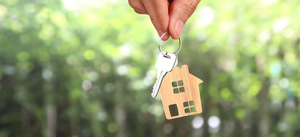 Agente inmobiliario entregando las llaves de una casa en mano - Foto, imagen