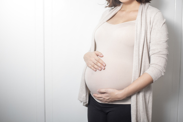 Close up pregnant woman expecting a baby - Fotó, kép