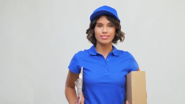 happy delivery girl with parcel box and clipboard - Filmagem, Vídeo