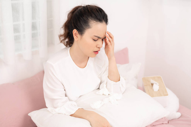 Imagem de mulher doente com dor de cabeça descansando na cama
 - Foto, Imagem