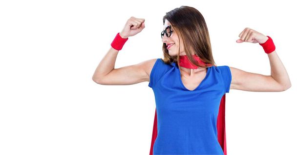 Digital animation of a woman wearing a cape, flexing her biceps with a white background. Medicine public health pandemic coronavirus Covid 19 outbreak concept digital composite. - Foto, Imagem
