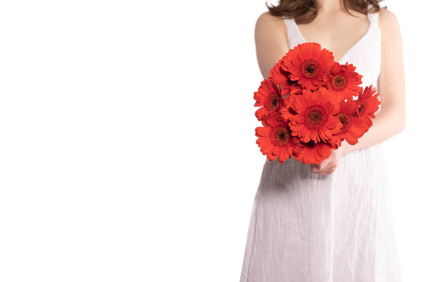 girl holding a bouquet of gerbera flowers on a white background - Photo, Image