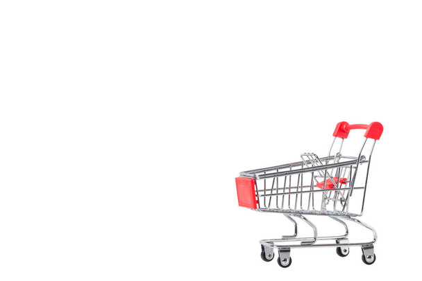 A Shopping Cart. Mini shopping trolley, isolated on white background. Mini Shopping Cart On The Table. Business , e-commerce concept. - Фото, изображение