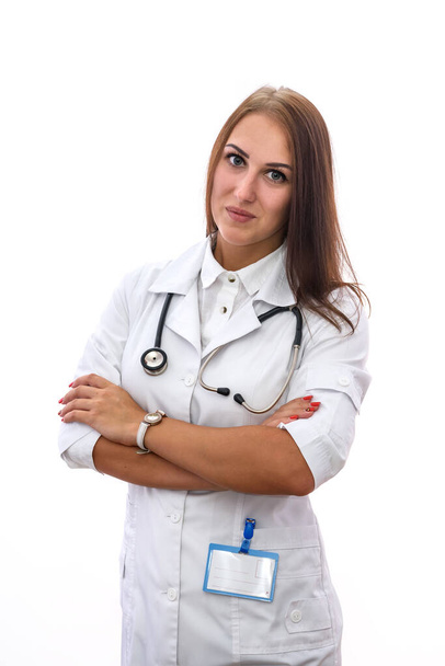 Smiling woman in white medical coat posing with stethoscope isolated on white - 写真・画像