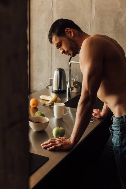 selektivní zaměření vousatého muže stojící u stolu s ovocem  - Fotografie, Obrázek