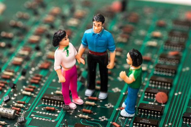 Close Up of toy people on green electronic circuit board - Fotografie, Obrázek