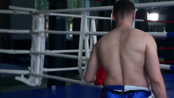Boxer Fighter Takes Sports Bag and Hoodie Sweatshirt Sweater and Leaves Gym After Training. Slow motion 1/2 speed 60 fps 4K - Materiał filmowy, wideo