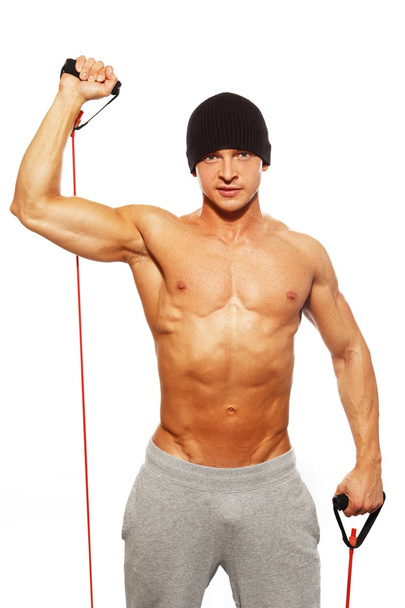 pohledný muž s svalnaté tělo dělá fitness cvičení - Fotografie, Obrázek