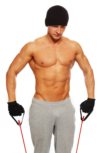 przystojny mężczyzna z muskularne ciało robienie ćwiczeń fitness - Zdjęcie, obraz