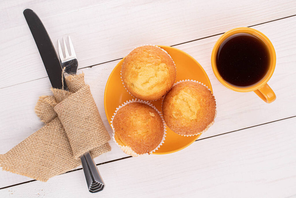 Group of three whole small baked muffin breakfast on white wood - 写真・画像