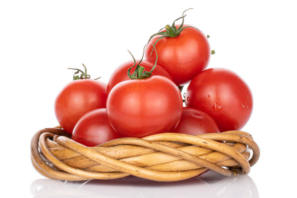 Lot of whole fresh red cherry tomato with wicker ring made of twigs isolated on white - Foto, immagini