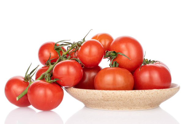 Lot of whole fresh red cherry tomato on vine on ceramic plate isolated on white - Φωτογραφία, εικόνα
