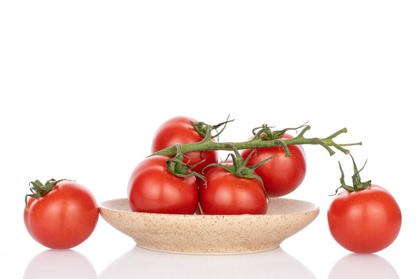 Lot of whole fresh red cherry tomato on ceramic plate isolated on white - Fotoğraf, Görsel