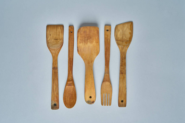 Row Of Assorted Old Wooden Kitchen Utensils. Top view - Photo, image