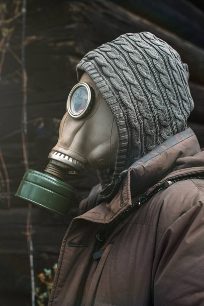 Portrait of a man in a gas mask. Panic during quarantine. Coronavirus pandemia concept. Stalker in a gas mask, Chernobyl Exclusion Zone - Photo, Image