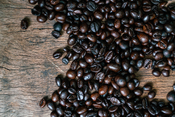 Roasted coffee bean flat lay on wood background, coffee industry - Photo, Image