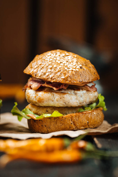 Primer plano sabrosa hamburguesa chiken fondo de madera oscura
 - Foto, imagen