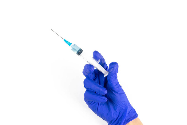 Protection of the body against the virus. Vaccination, the doctor holds a syringe in his hand, close-up isolated on white background. - 写真・画像
