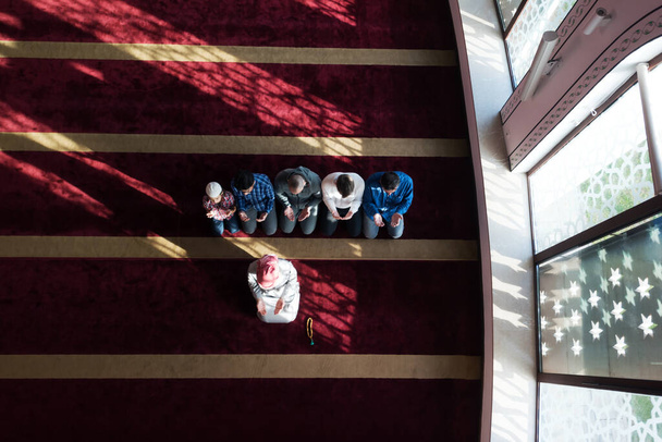 Ομάδα νεαρών Μουσουλμάνων προσεύχονται. Μουσουλμανικές προσευχές κάνουν προσευχή μέσα στο τζαμί. - Φωτογραφία, εικόνα