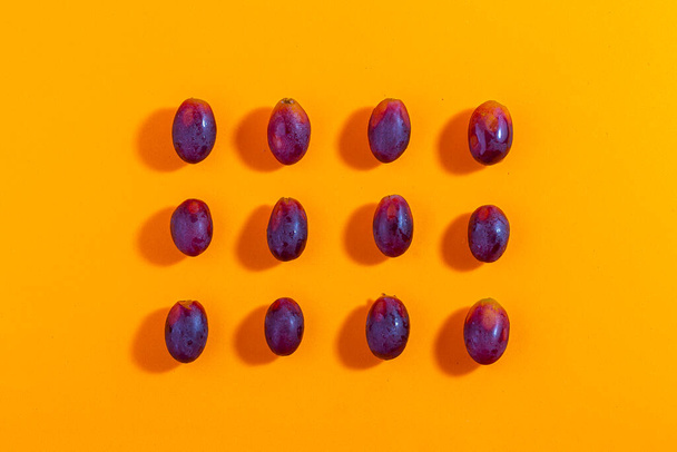 Set of fresh grapes isolated on orange background, top view, concept photo. - Foto, Bild