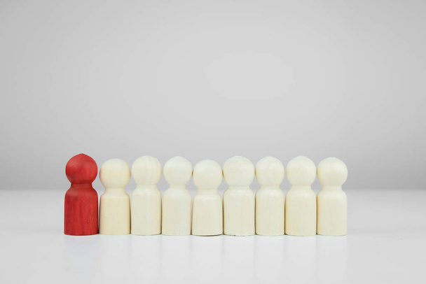 Red man stand among the other figures of people. Concept of leader, leadership. Confidence and severance.  - Photo, Image