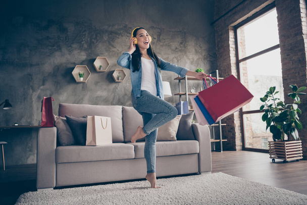 Full length body size view of her she nice attractive lovely cheerful cheery funky girl carrying new clothes things listening melody having fun in modern loft industrial house apartment - Valokuva, kuva