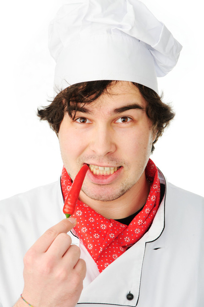 Chef in uniform holding hot chili pepper - Fotó, kép