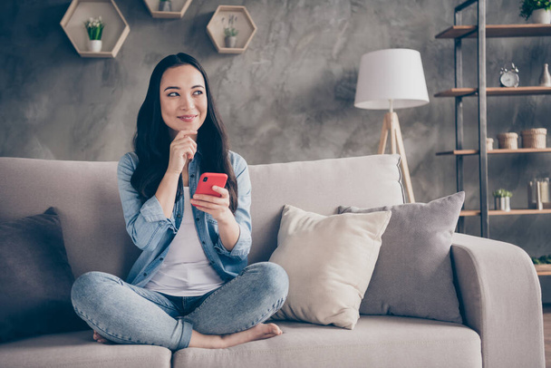 Portrait of her she nice attractive lovely pretty cute creative cheerful girl sitting on divan using device 5g app creating new smm post spending free time in modern loft industrial house apartment - Fotoğraf, Görsel