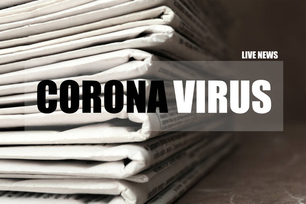 Zwrot Corona Wirus i stos gazet na stole, zbliżenie. Praca dziennikarza - Zdjęcie, obraz