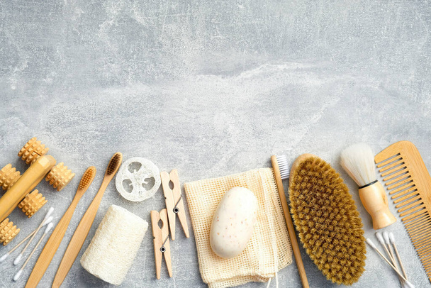 Bath accessories and natural SPA cosmetic products on stone background. Flat lay, top view. Personal hygiene and body treatment concept - Photo, image