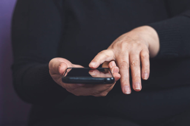 Senior woman text messaging on smartphone in home - Φωτογραφία, εικόνα