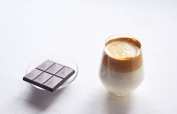 Cold coffee cream with cold Dalgon milk.Trend. In a transparent glass on a white background. - Фото, изображение