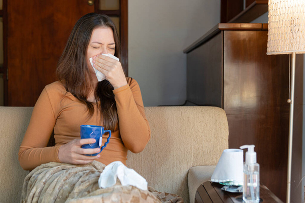 Woman sitting on the couch with a cold. Feeling Sick Concept. - Photo, Image