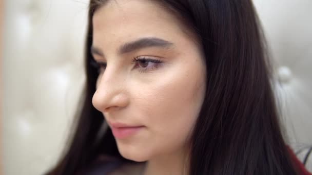 Young brunette woman close up face, focused on distance work or studying - Footage, Video
