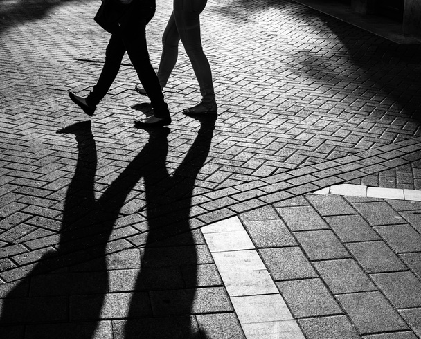 Shadows of people walking street - Photo, Image