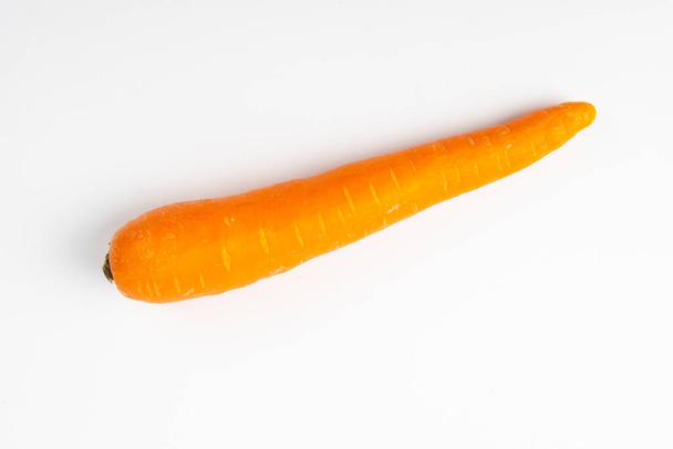 Fresh raw carrot isolated on white background. - Фото, изображение