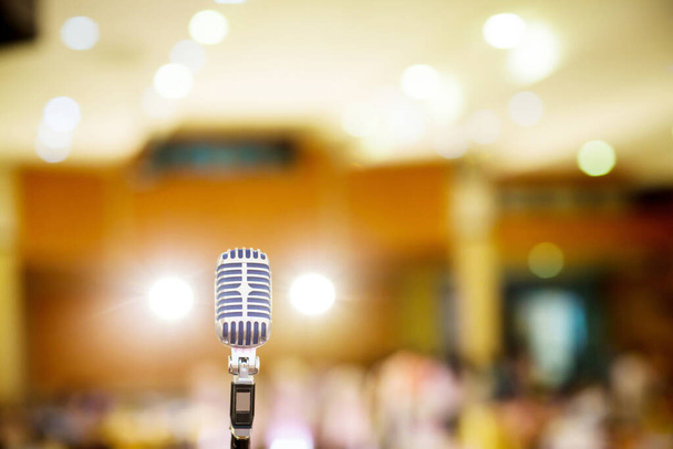 microphone vintage style in concert hall or conference and meeting room. soft and blur style for background. Microphone over the Abstract blurred photo of conference hall  - Φωτογραφία, εικόνα