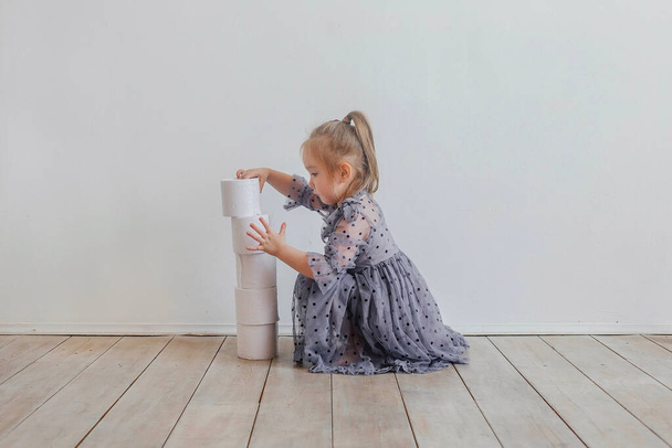 little cute girl is playing with toilet paper - Фото, зображення