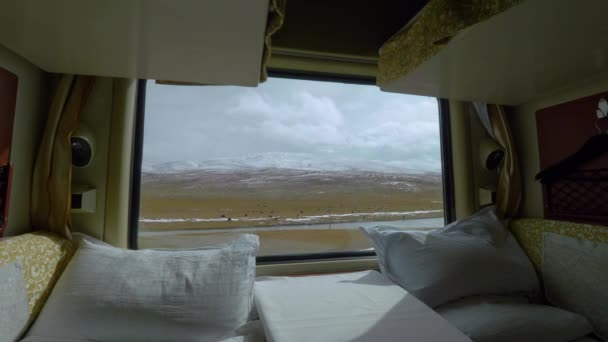 CLOSE UP: Scenic shot of Tibetan plains through the window of a sleeper train. - Footage, Video
