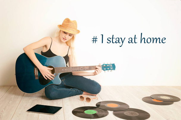 Blonde Woman with a guitar during Lock Down. I stay home concept - Photo, Image