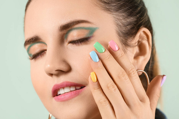 Young woman with beautiful manicure on color background, closeup - Photo, Image