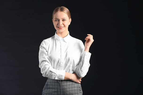 Portrait of young businesswoman on dark background - Photo, Image