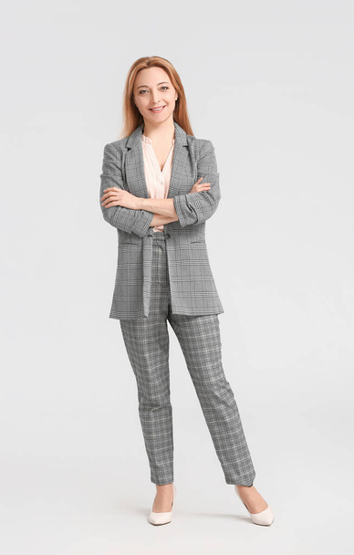 Portrait of stylish businesswoman on light background - Foto, Bild