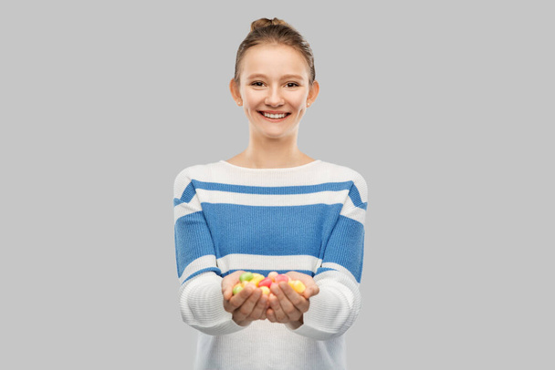 happy smiling teenage girl holding candies - Φωτογραφία, εικόνα