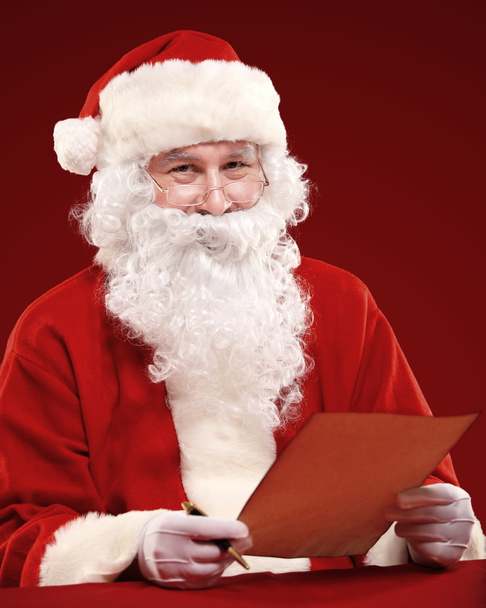 Santa Claus holding Christmas letter - Foto, Imagen
