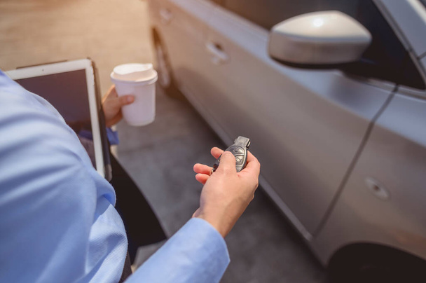 businesswoman, working, business, car, multitasking, technology concept. Close-up of the hand, Businesswoman opening the car door with coffee cup and laptop. - Fotoğraf, Görsel