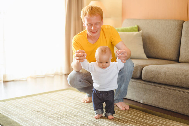 Father take toddler baby son to walk at home in holiday. Family, father, son, baby, Happy, lifestyle concept. - 写真・画像