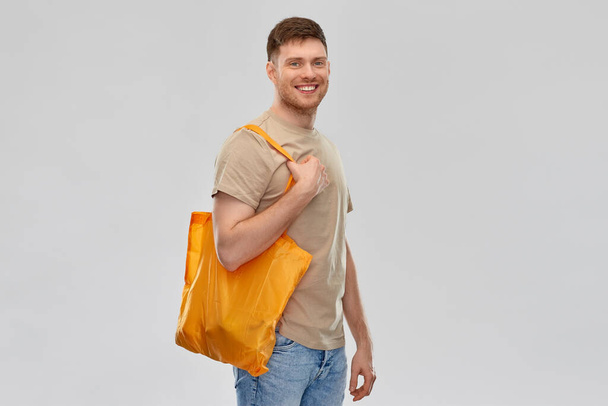 man with reusable canvas bag for food shopping - 写真・画像