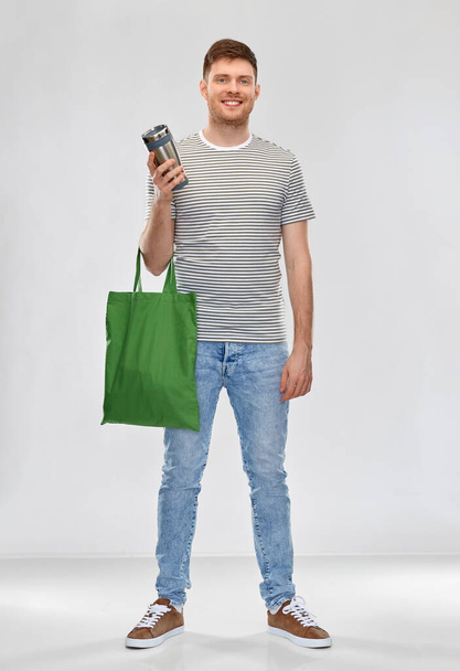 man with bag for food shopping and tumbler - Foto, afbeelding