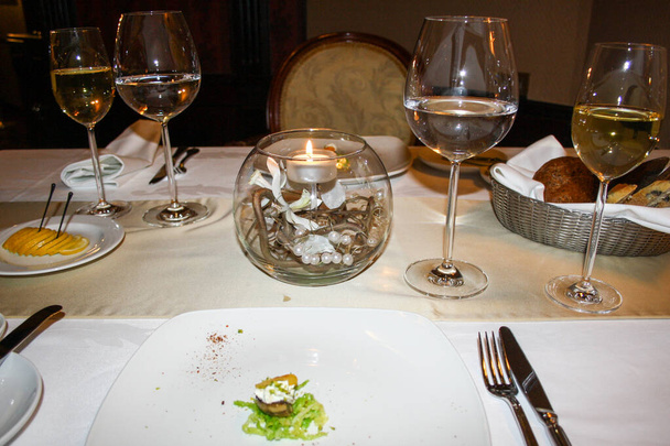 Dinner on the table in the evening in a restaurant - Photo, Image